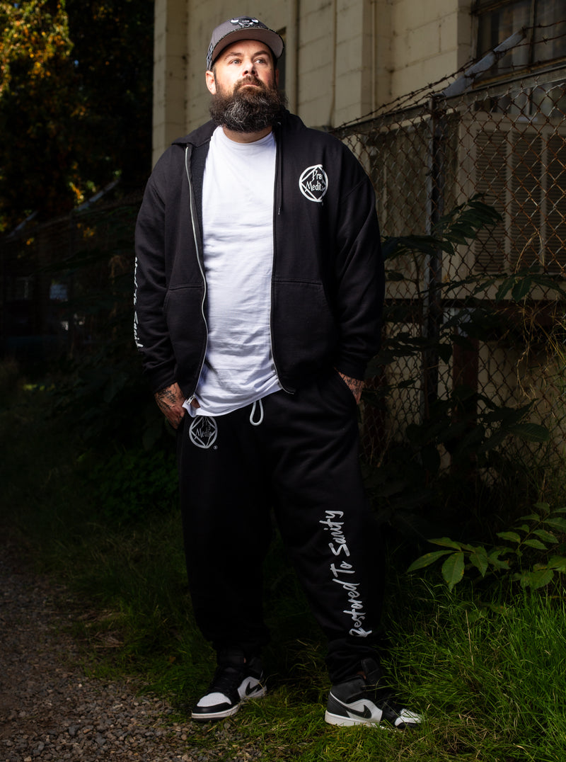 Load image into Gallery viewer, black tracksuit with white text and a logo
