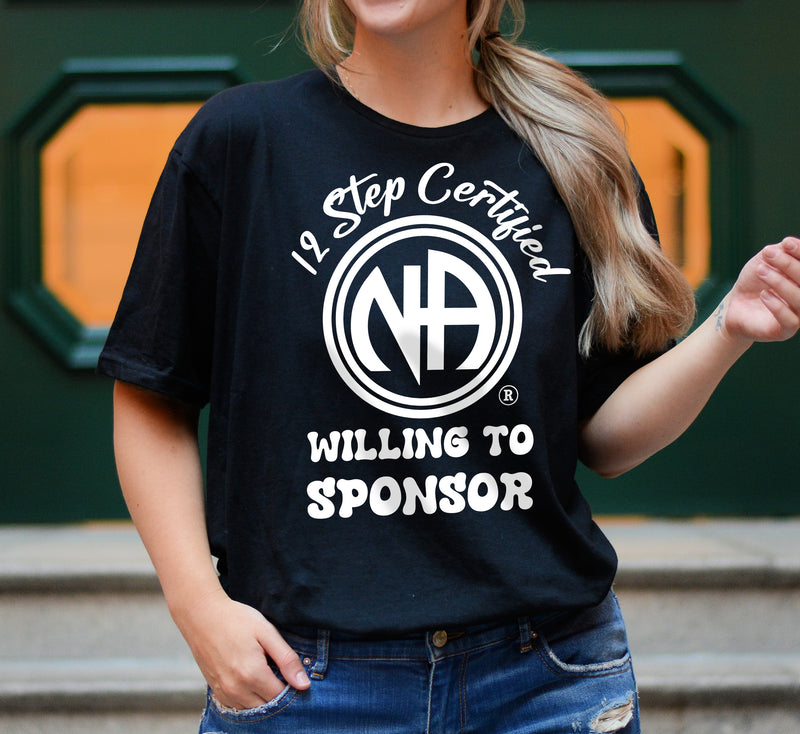 Load image into Gallery viewer, Person wearing a black t-shirt with '12 Step Certified Willing to Sponsor' text and logo.
