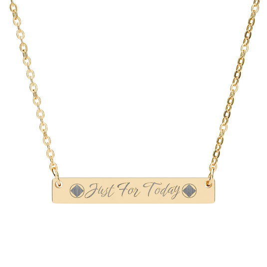 Gold necklace with a bar pendant inscribed 'Just For Today' on a white background