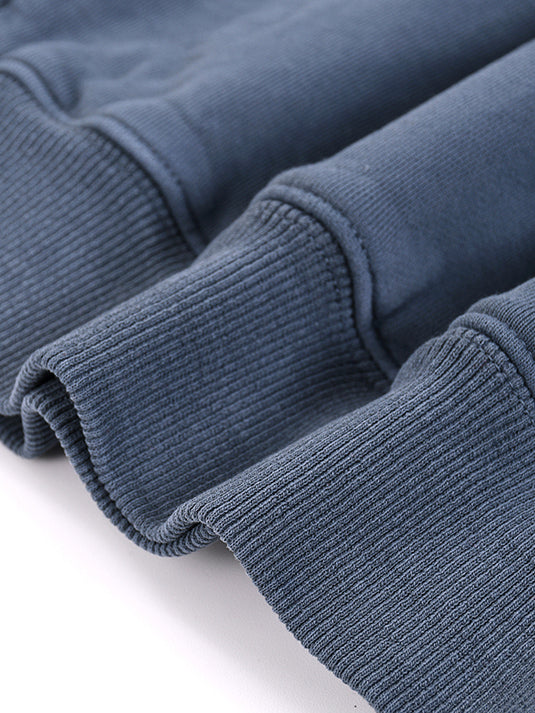 Close-up of blue fabric with ribbed texture on a white background