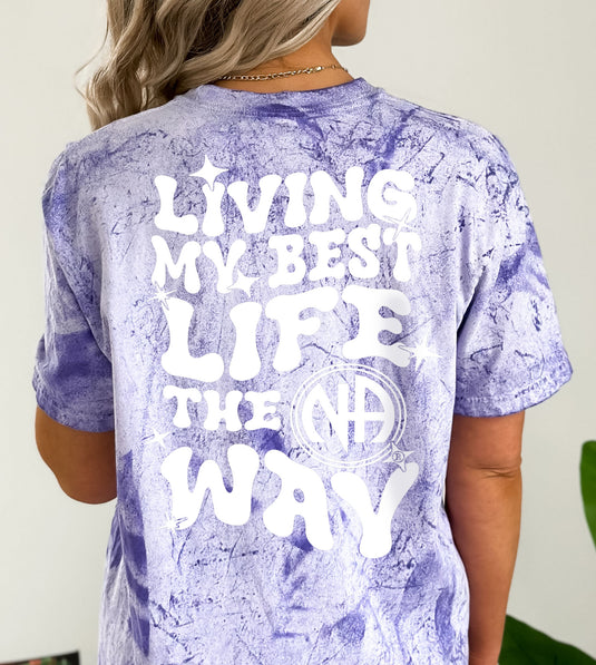 Person wearing a purple tie-dye t-shirt with text on the back
