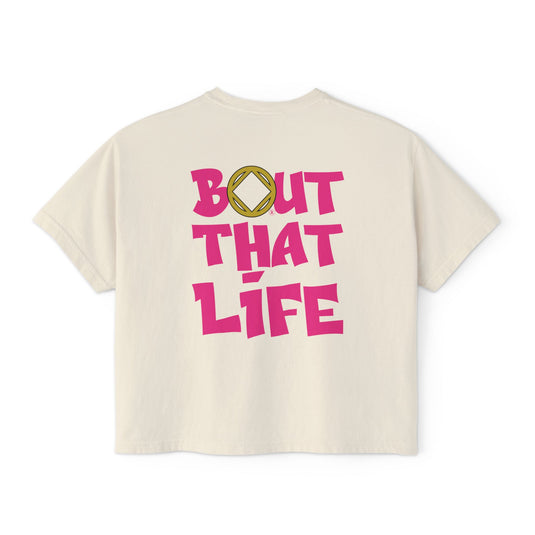 Beige t-shirt with pink text 'BOUT THAT LIFE'