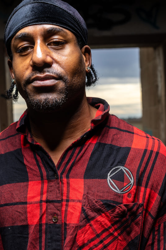 red and black plaid shirt with a NA logo