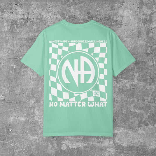 Green t-shirt with white graphic design on a gray concrete background