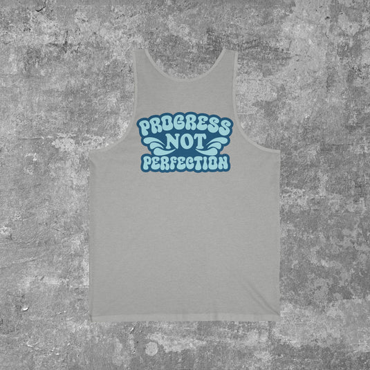 Gray tank top with 'Progress Not Perfection' text on a textured gray background