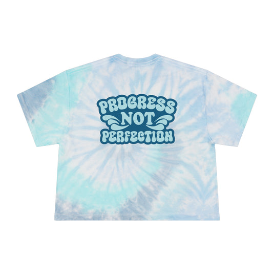 Tie-dye t-shirt with 'Progress Not Perfection' text on a white background