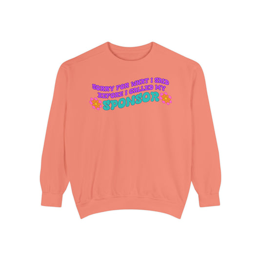 Coral sweatshirt with colorful text on a white background