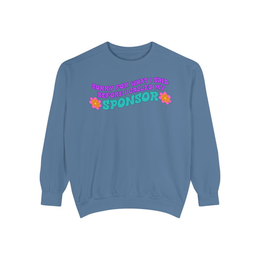 Blue sweatshirt with colorful text and flower graphics on a white background